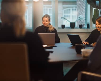 People sitting at a table in a meeting