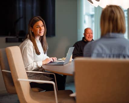 Two people looking at a screen device.