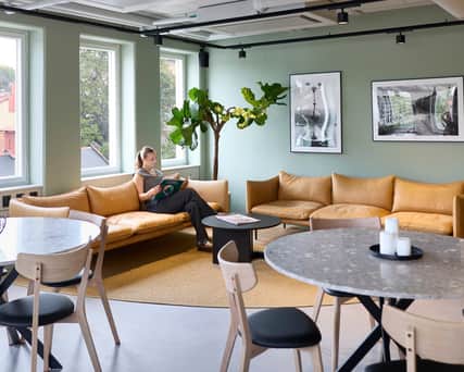 Woman reading in office lounge