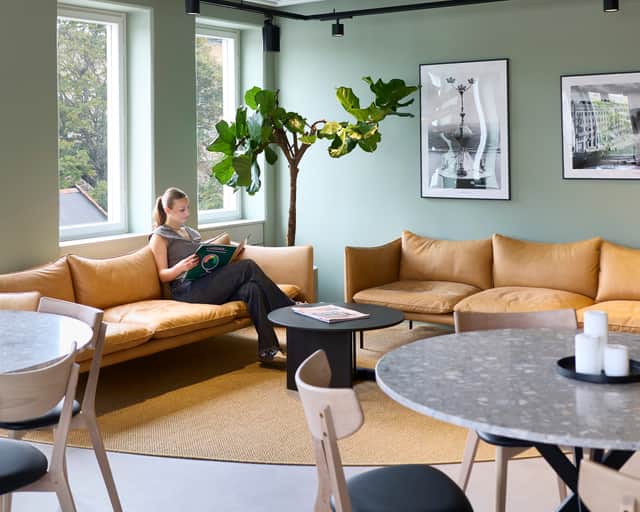 Two people sitting in a sofa.